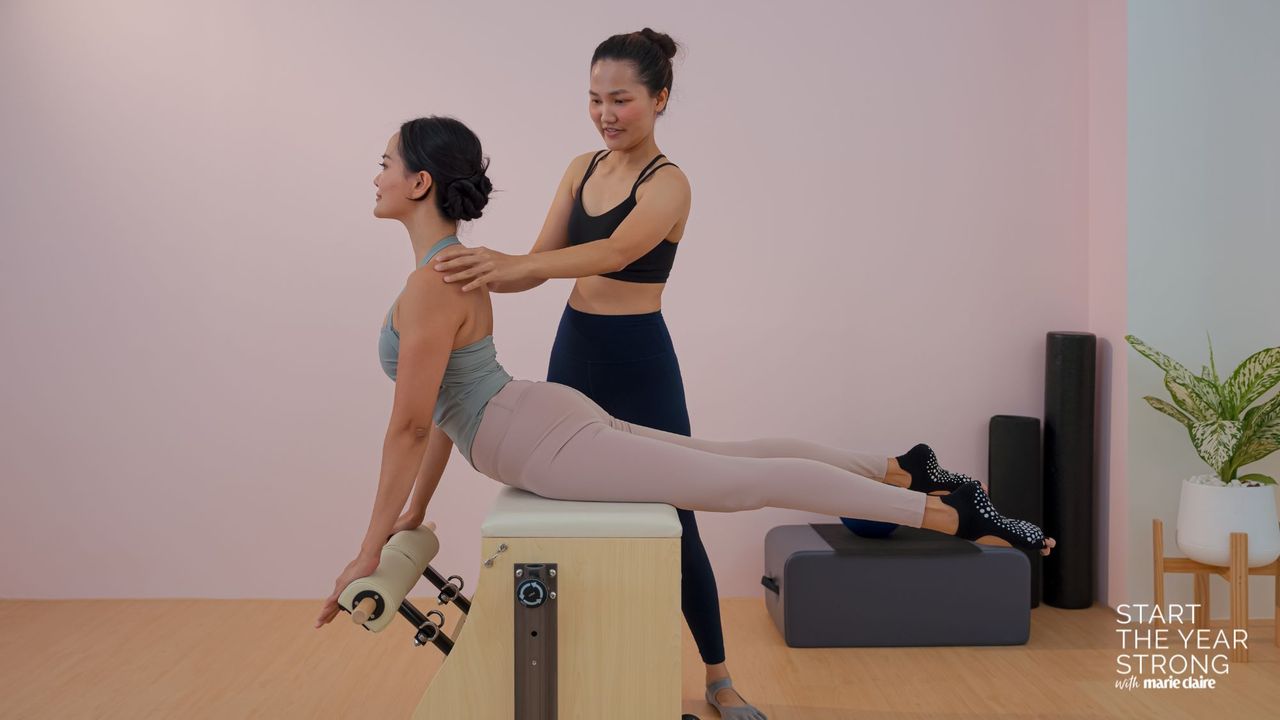 A woman trying vertical Pilates in studio