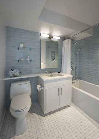 A modern bathroom with blue tiled walls and a built in bath