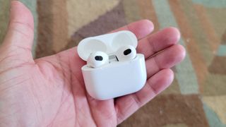 The Apple AirPods 3's charging case held in hand