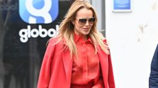Amanda holden wearing a red shirt, coat and trouser outfit