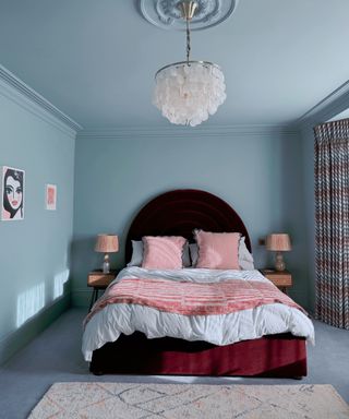 Blue color drenched bedroom with pink bedding