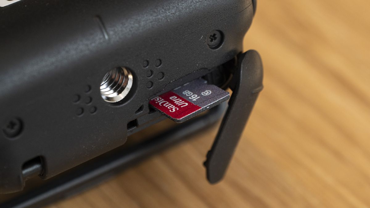 Canon Powershot V10 on a table closeup of memory card door