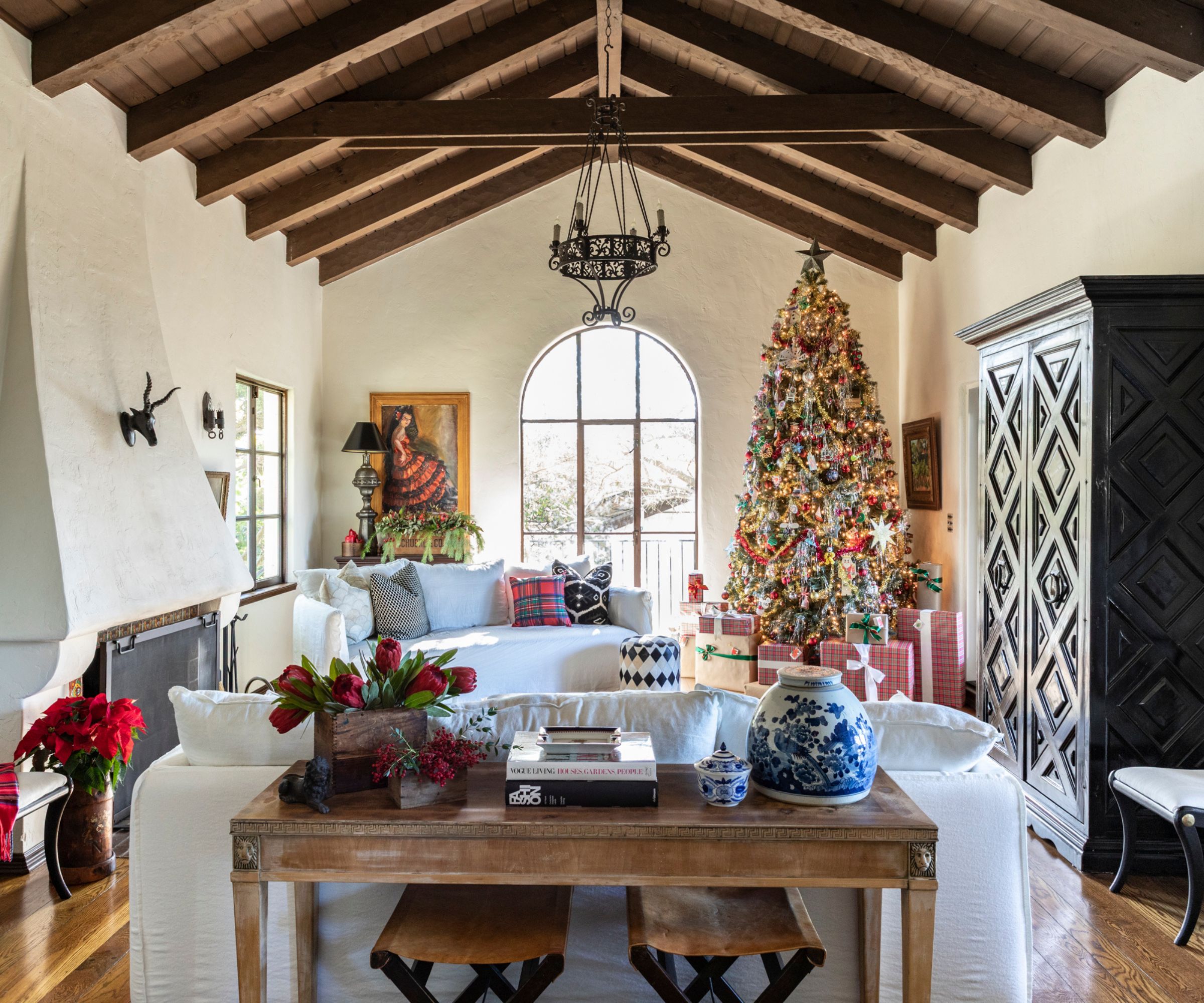 A Spanish-style home living room decorated for the holidays with a Ralph Lauren-inspired scheme