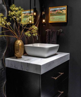 Black bathroom with brass hardware