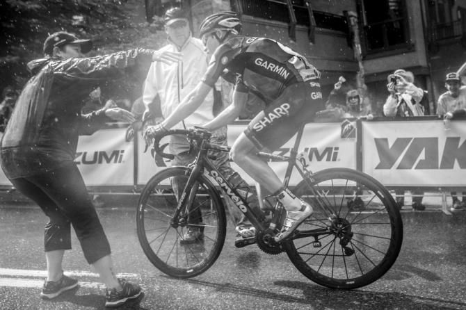 Tom Danielson (Garmin Sharp) gets some help after crossing the finish line.