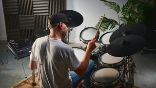 Man playing the Roland TD716 drum set