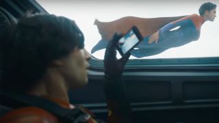 Barry Allen takes a photograph of Supergirl flying in The Flash movie