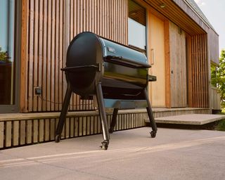 large black wood pellet grill on a patio