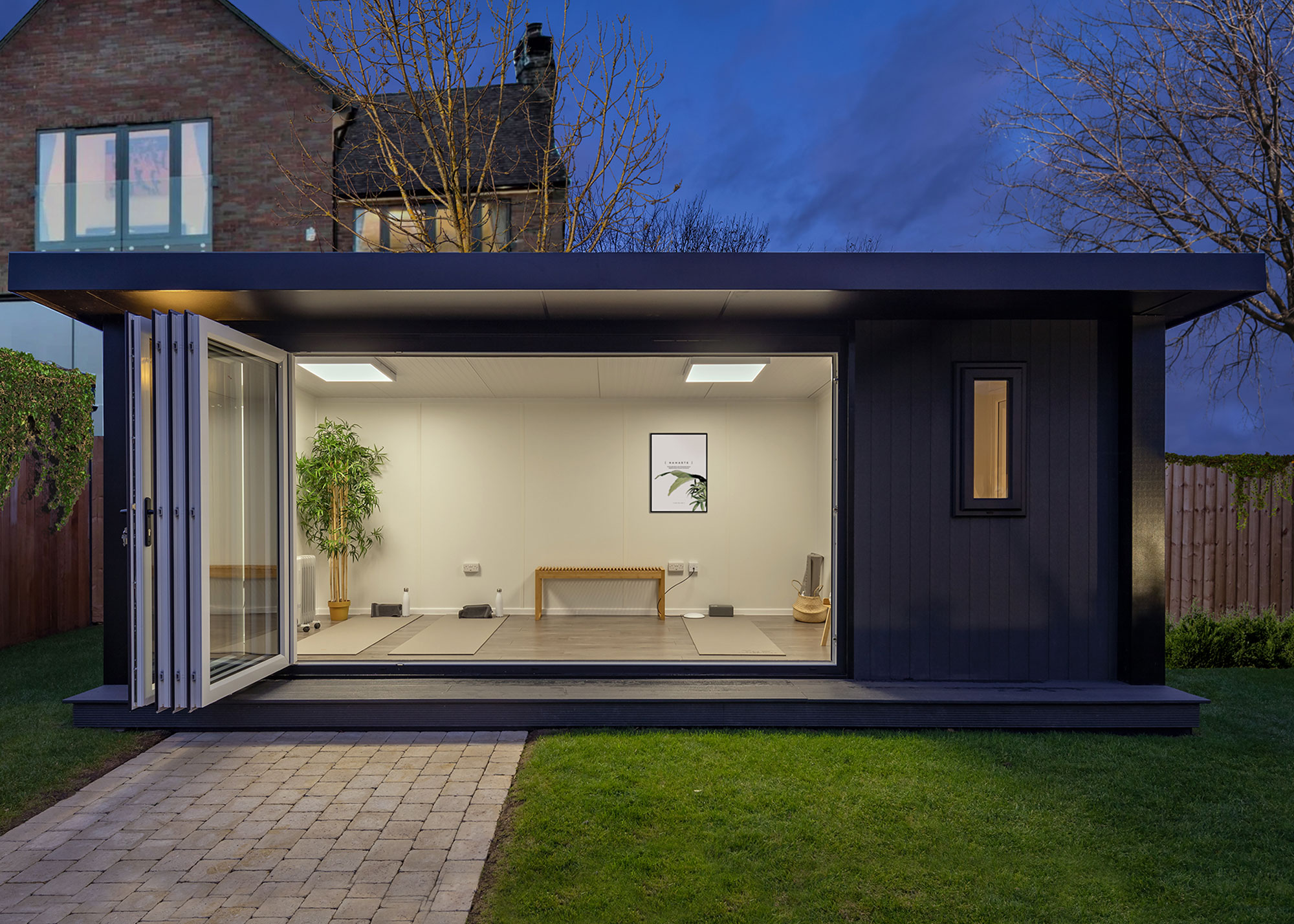 yoga studio in a brightly lit garden room, path and lawn