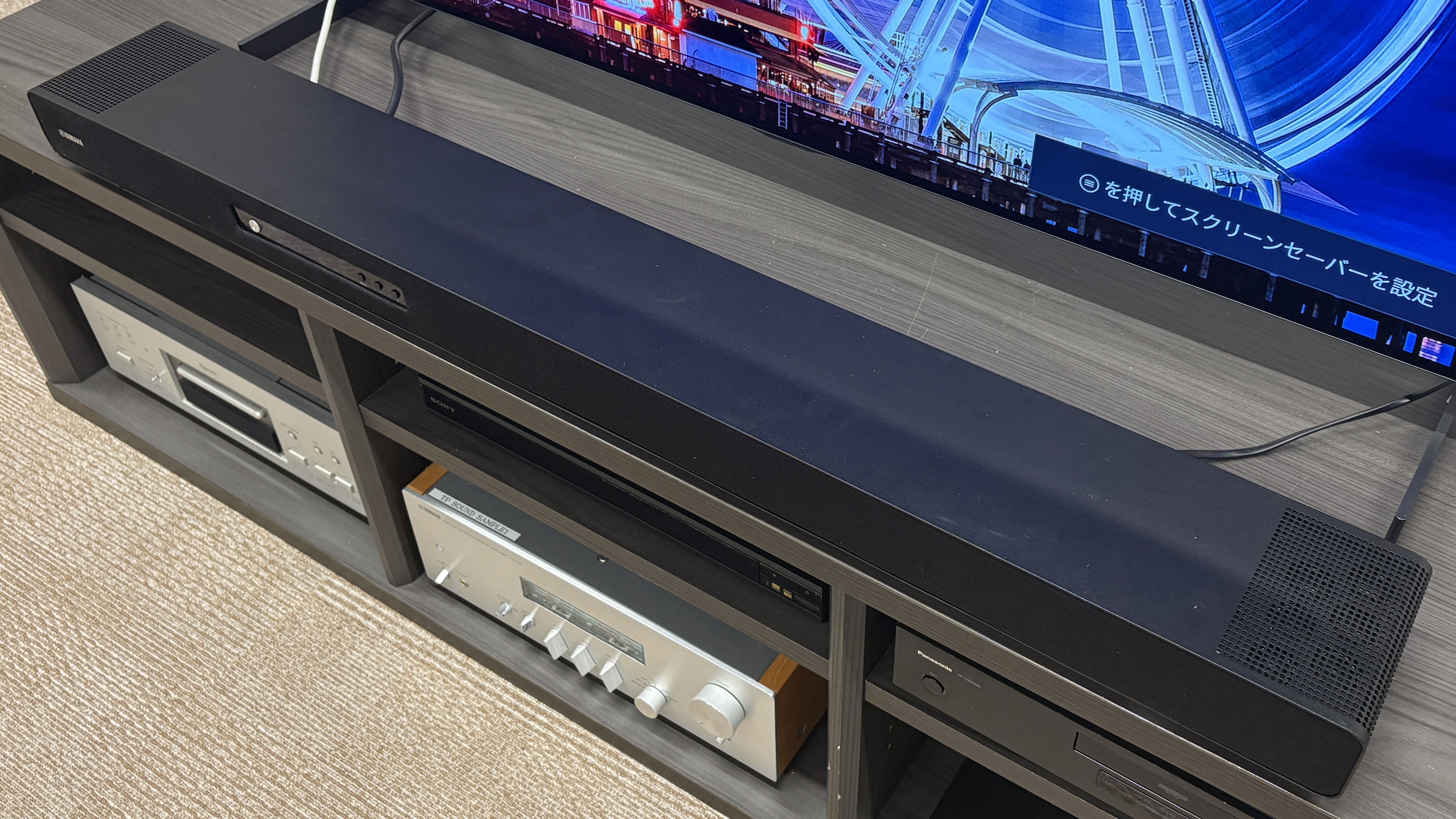 Yamaha True 90A soundbar on a media unit below a TV