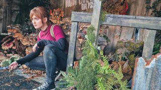 A photo of an individual dressed as Ellie from the Last of Us against an overgrown background