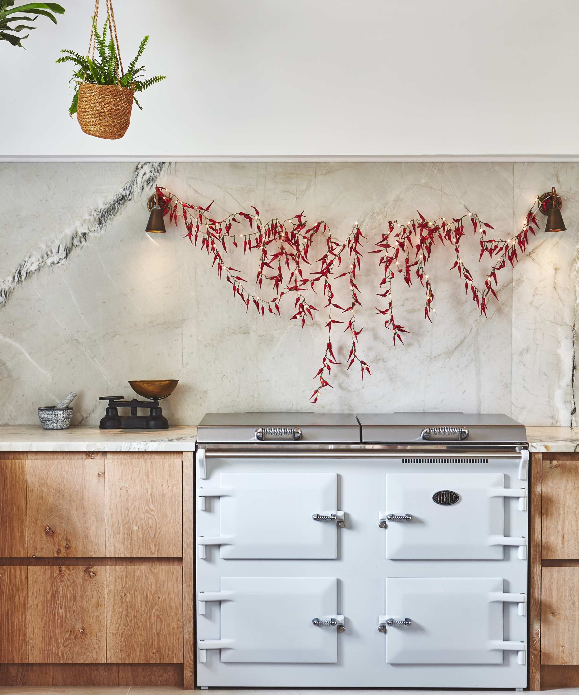 string of chilli shaped lights hung over splashback behind white range cooker