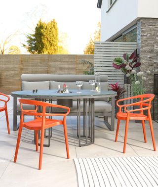 colourful garden furniture ideas: orange chairs on patio