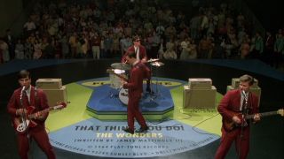 Johnathon Schaech, Tom Everett Scott, Ethan Embry, and Steve Zahn perform on a giant vinyl graphic in That Thing You Do!