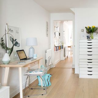 home office with wooden flooring and drawers