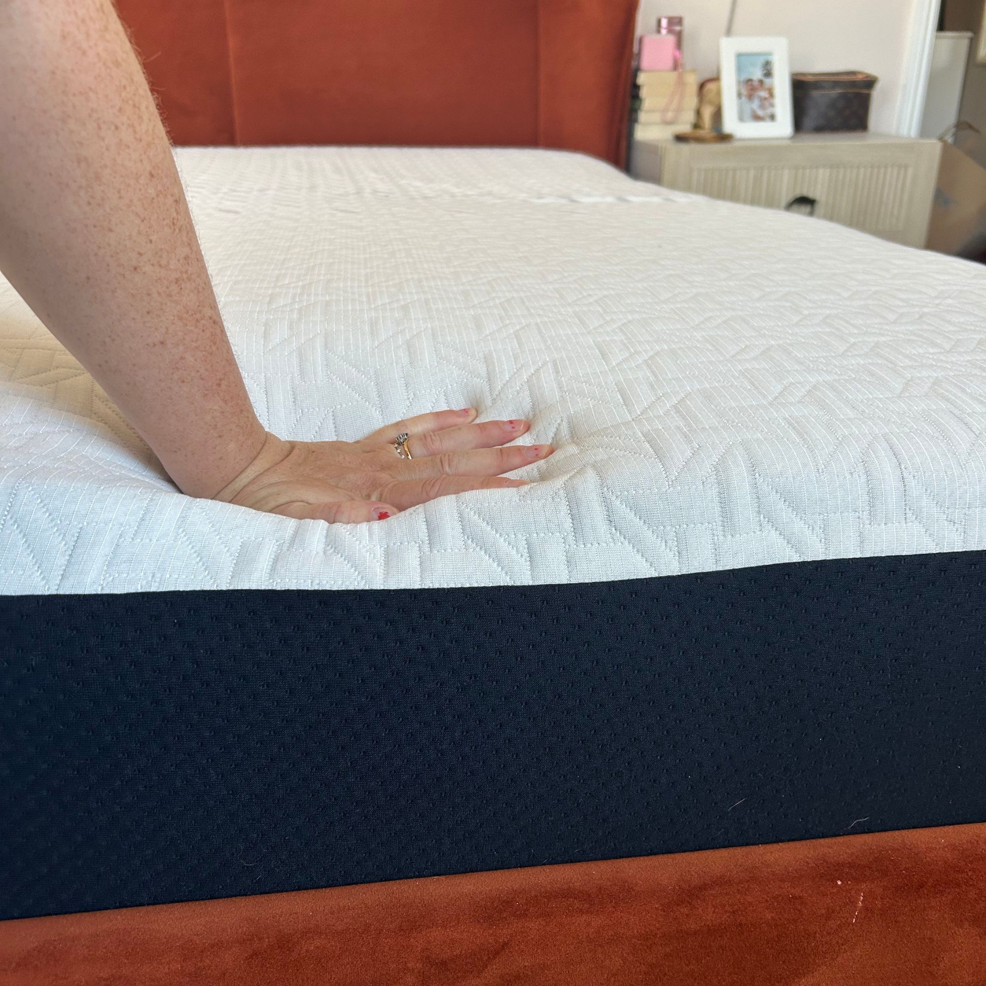 Nectar mattress on bed with hand pushing into base