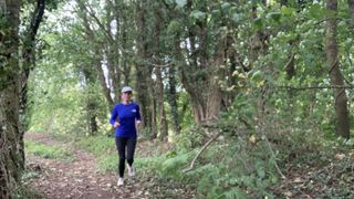 Woman trail running in the woods