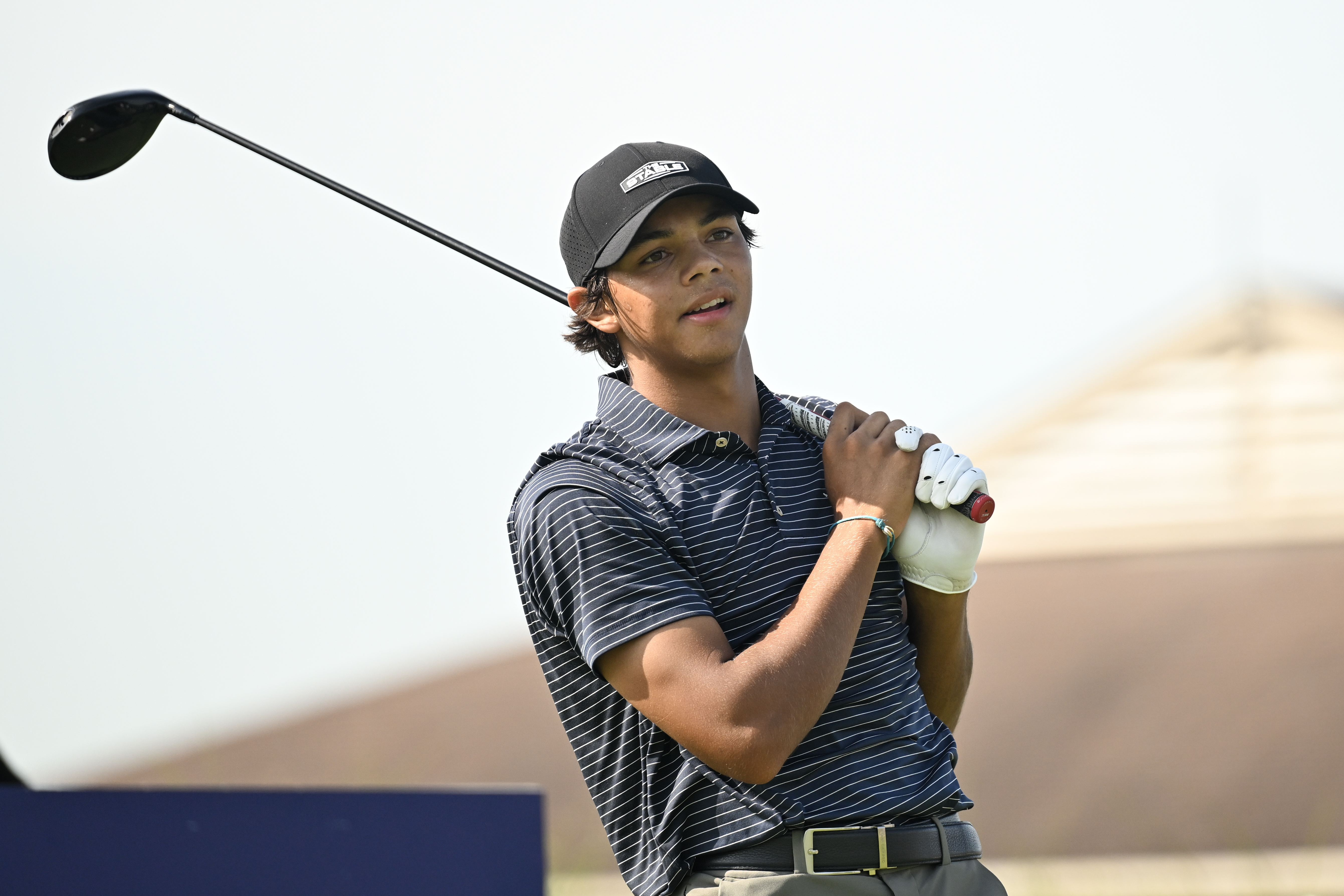 Charlie Woods hits a tee shot with a driver
