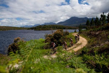 Riders skirt the edge of a dam during Stage 5 from Herold to George