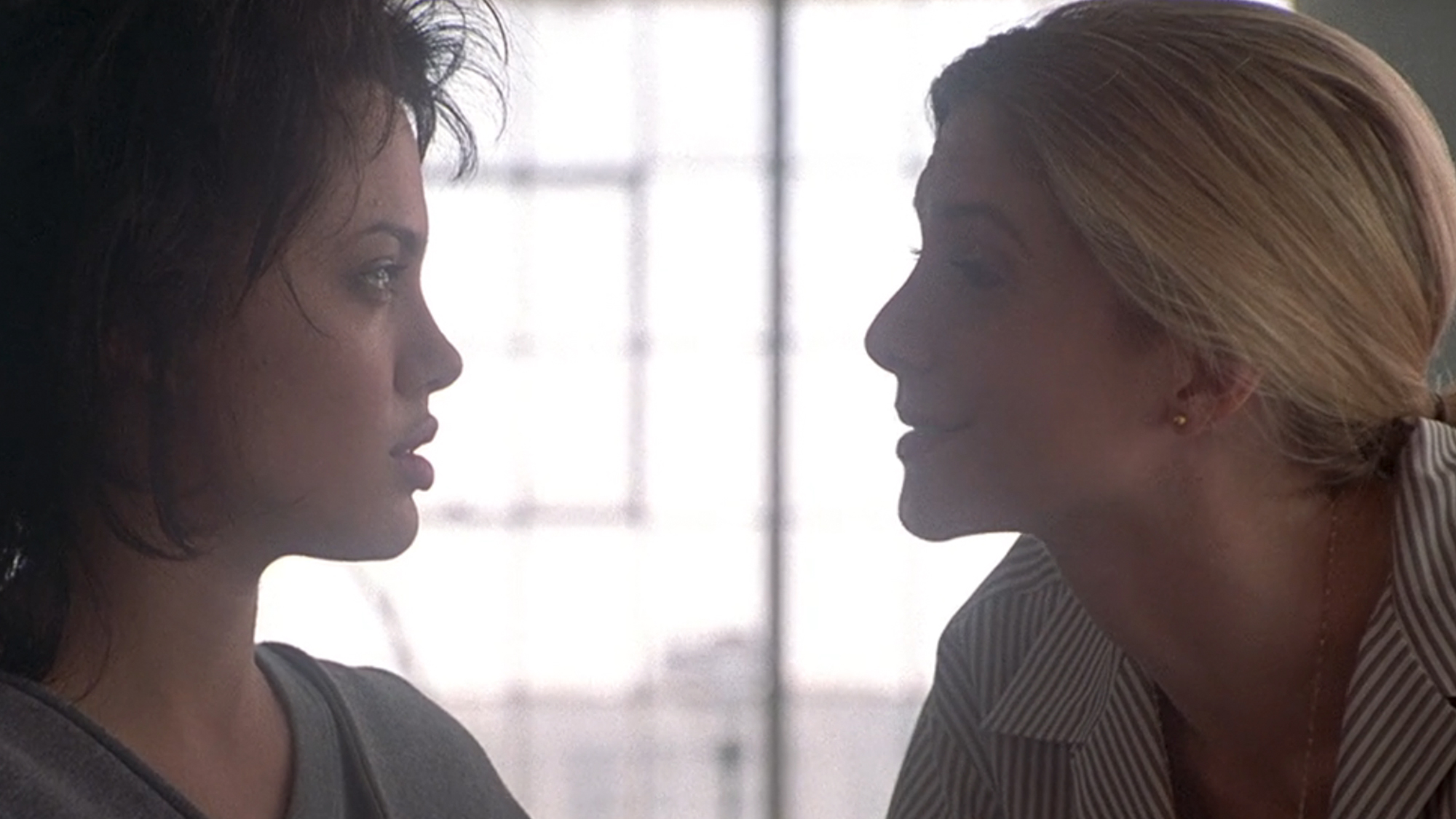 A close up of Angelina Jolie and Elizabeth Mitchell talking in Gia