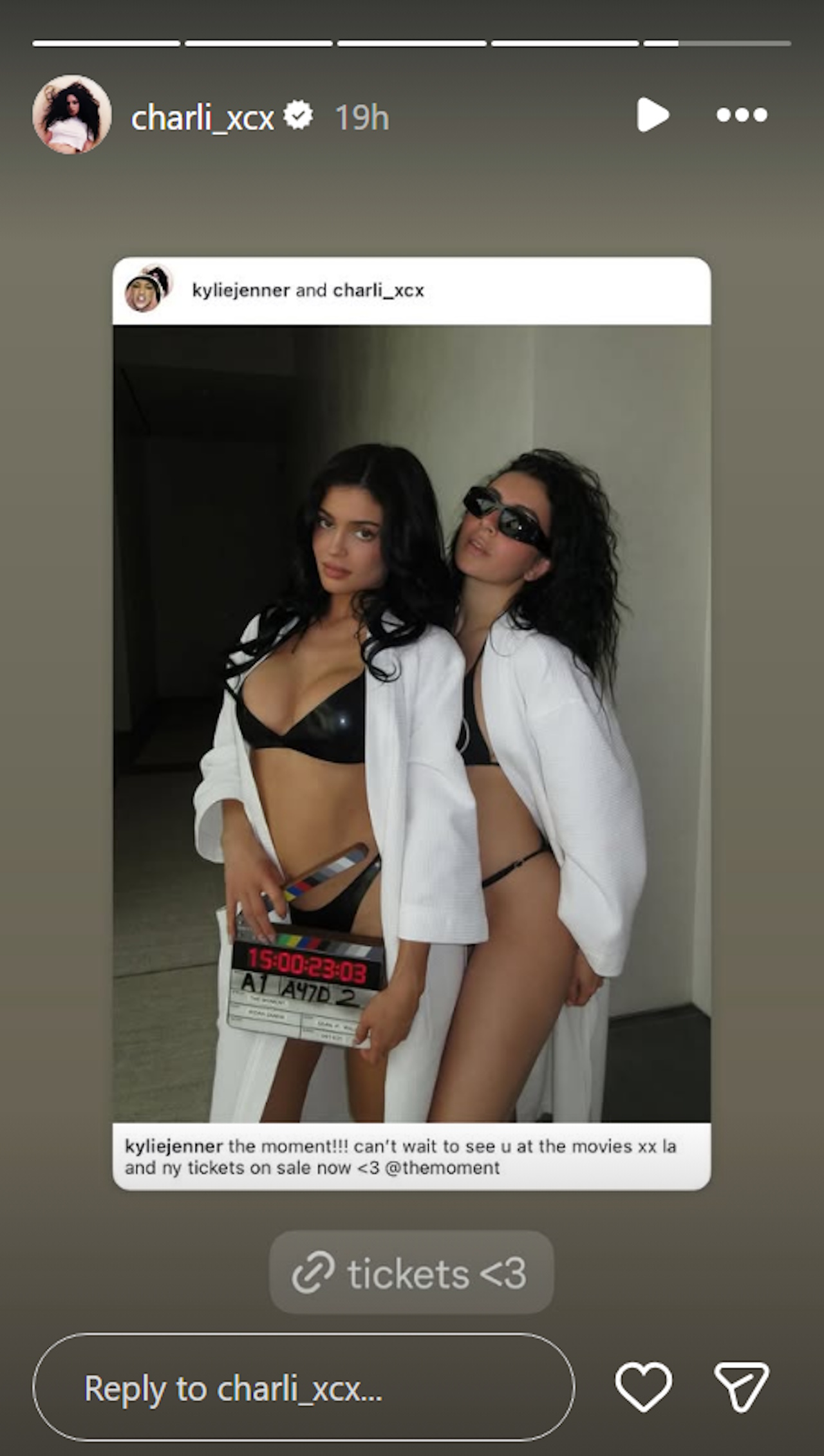 Kylie Jenner and Charli XCX pose for a photo in black latex bikinis as they promote their A24 movie The Moment.