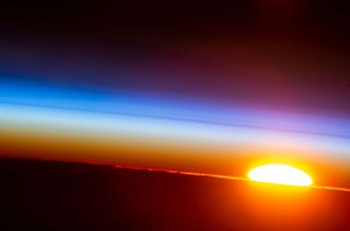 An orbital sunrise is pictured from the International Space Station as it orbited 262 miles above Bolivia on the South American continent.