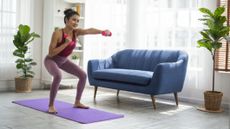 Woman exercises at home with small dumbbells