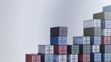 illustration of a bunch of shipping containers of different colors, stacked in rows that suggest an upward trend from left to right