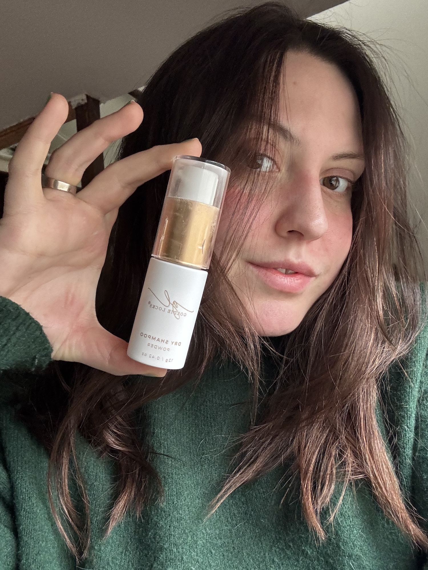Sophia Vilensky holding a bottle of Goldie Locks Dry Shampoo.