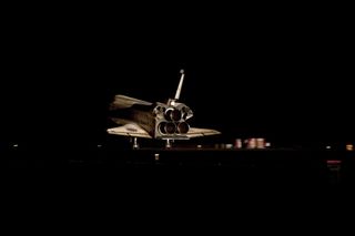 Space shuttle Atlantis gleamed in the darkness at it touched down on the Shuttle Landing Facility's Runway 15 at NASA's Kennedy Space Center in Florida for the final time. Atlantis' wheels came to a stop at 5:57:54 am on Thursday, July 21, 2011.