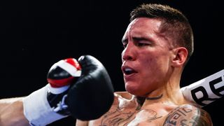 Oscar Valdez of Mexico leans back against the ropes to dodge a punch ahead of the Emanuel Navarrete vs Oscar Valdez fight. 