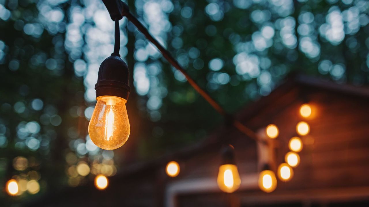 Festoon lights hanging in a backyard 