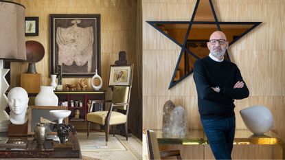 A middle-aged man with salt and pepper beard, a black jumper, and a white shirt underneath it stands with his arms crossed in front of a wooden paneled wall featuring a star-shaped decoration.