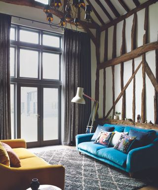 Yellow and blue sofa, white lamp, grey rug