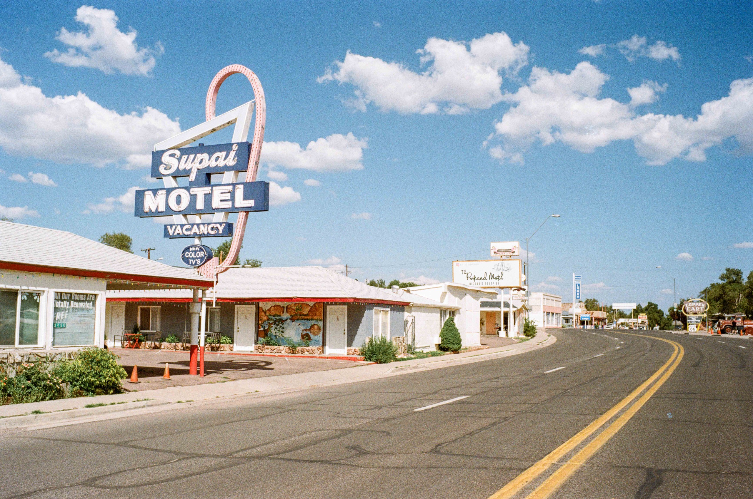 Retro-style photographs of the Route 66 road, motels and vintage vehicles