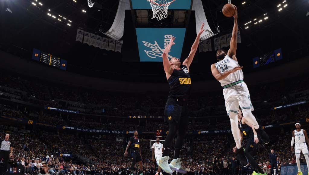 Karl-Anthony Towns #32 of the Minnesota Timberwolves goes to the basket during the game against Nikola Jokic #15 of the Denver Nuggets during Round 2 Game 7 of the 2024 NBA Playoffs on May 19, 2024