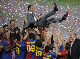Barcelona players lift their coach Pep Guardiola in celebration of their Spanish league title 2009 after their Spanish League football match against Osasuna on May 23, 2009 at Camp Nou stadium in Barcelona. Barcelona became champions without even taking to the field as second-placed Real Madrid lost away at Villarreal on May 16.