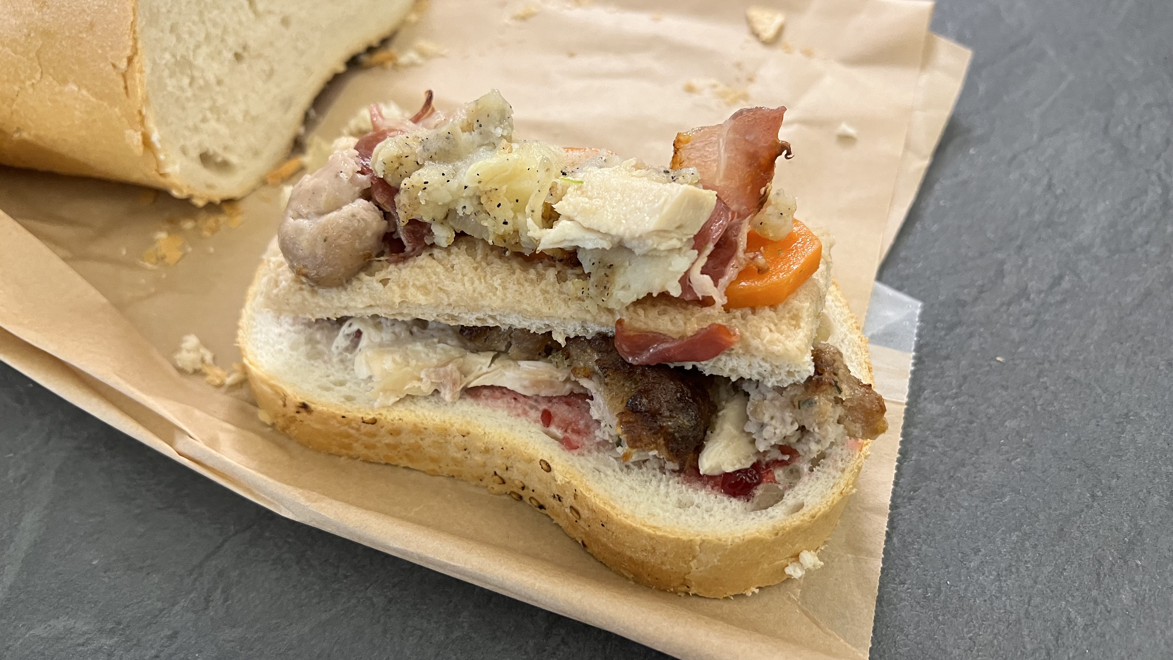 Christmas leftovers layered inside a bloomer bread sandwich