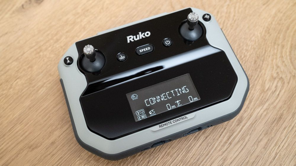 Ruko F11PRO 2 drone controller on a wooden surface