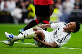 MADRID, SPAIN - NOVEMBER 09: Éder Militao of Real Madrid CF lay injured on the ground during the LaLiga match between Real Madrid CF and CA Osasuna at Estadio Santiago Bernabeu on November 09, 2024 in Madrid, Spain. (Photo by Diego Souto/Getty Images)