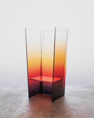 Glass chair by Germans Ermics with tall glass panels featuring colour gradient including black, red, yellow and white