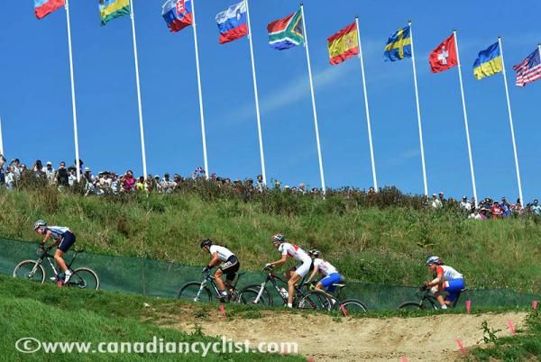The lead women fly past flags of many nations