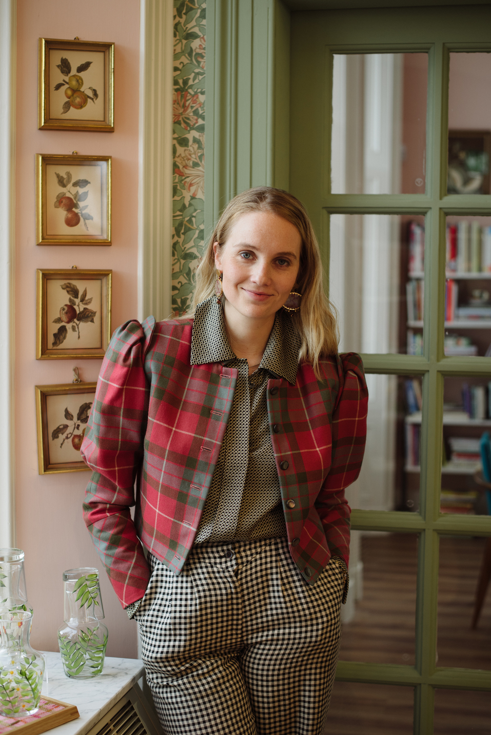 Petra Palumbo stands in a red tartan top and dogtooth check trousers