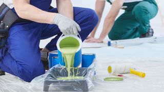 Pouring paint into a lined tray