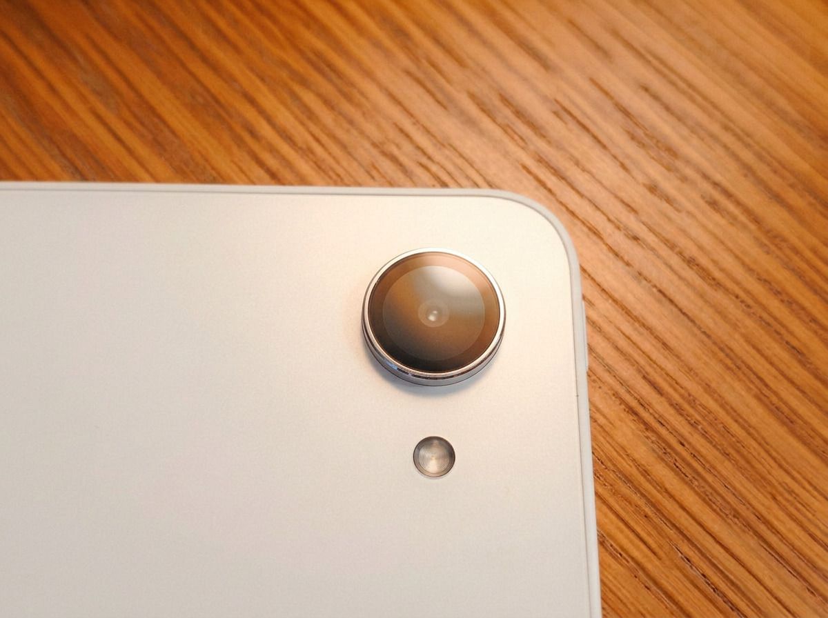 Photos of a white drawing tablet on a wooden table, the XPPen Magic Pro 13