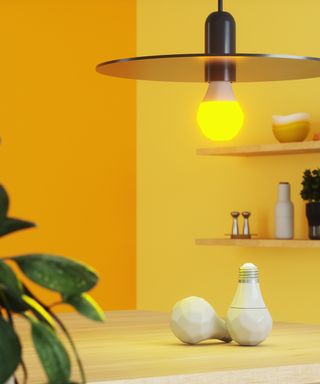 Smart bulb pictured in front of a yellow wall