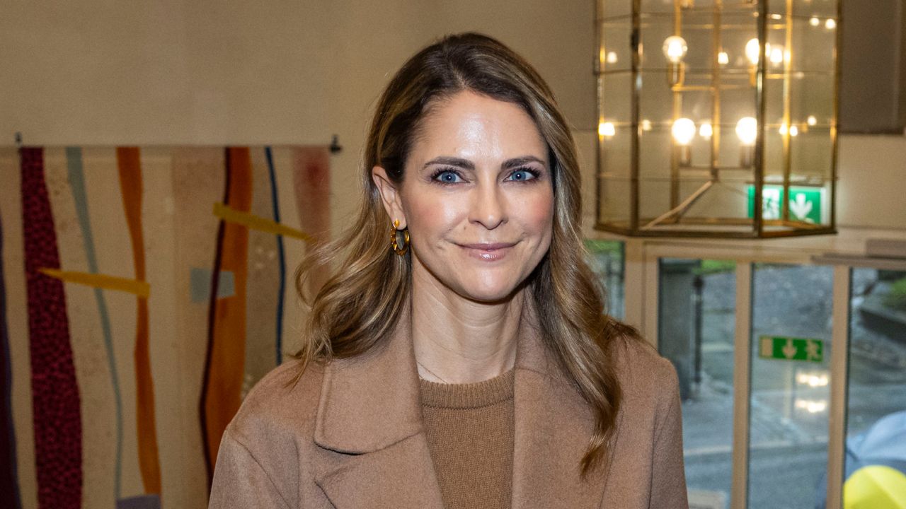 Princess Madeleine of Sweden wears a tan coat and brown top and shares a photo of her two daughters in scary Halloween outfits