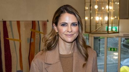 Princess Madeleine of Sweden wears a tan coat and brown top and shares a photo of her two daughters in scary Halloween outfits