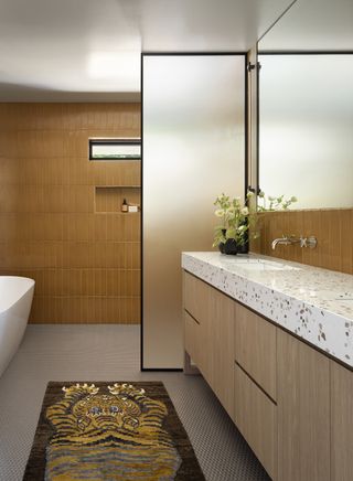 A bathroom with a half-partitioned frosted door