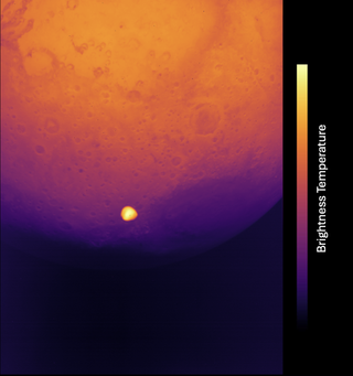 a thermal image showing a bright yellow speck against an orange-and-purple orb in the background